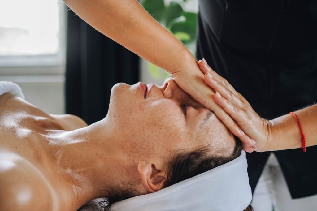 pexels-photo-9335967 Woman receiving a calming face massage in a peaceful spa environment.